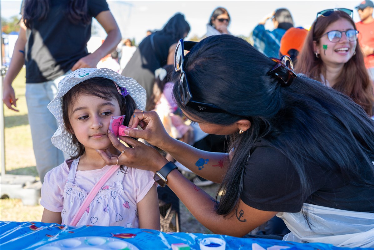 A child having their face painted